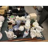 A LARGE GROUP OF CERAMIC NOVELTY TEAPOTS ETC