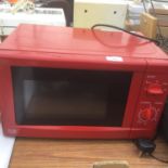A RED 700W MICROWAVE IN WORKING ORDER