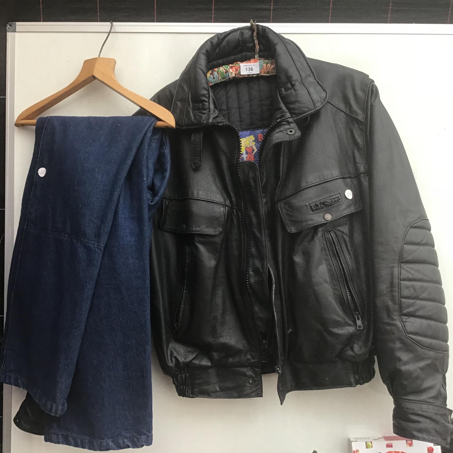 A BLACK LEATHER 'E.T' JACKET AND A PAIR OF JEANS
