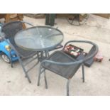 A ROUND GLASS TOP GARDEN TABLE WITH TWO CHAIRS