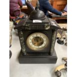 A STONE AND MARBLE EFFECT MANTLE CLOCK