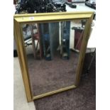 A LARGE GILT FRAMED MIRROR