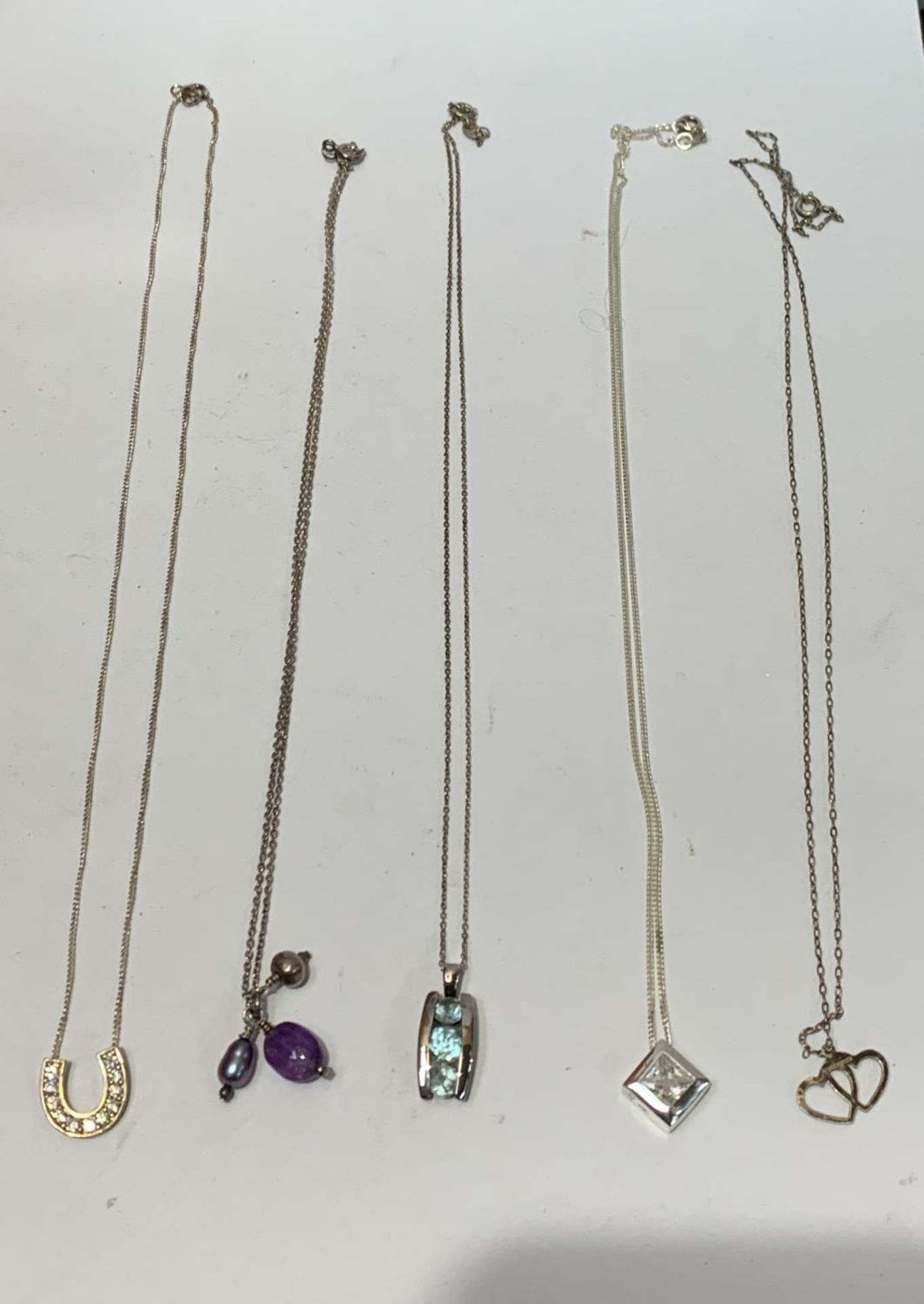 FIVE ASSORTED SILVER NECKLACES