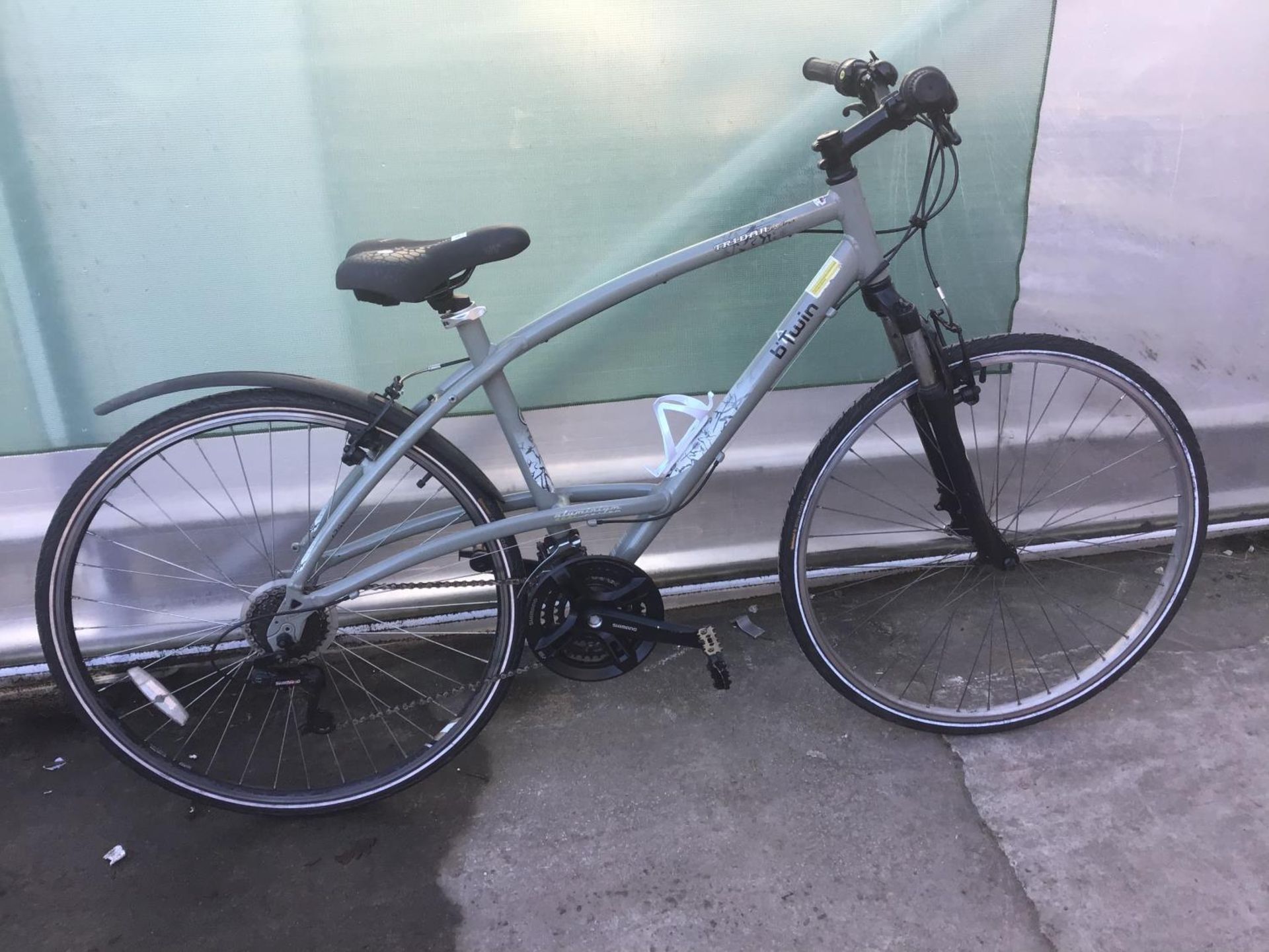 A TRIBAN BTWIN BIKE WITH A TWENTY ONE SPEED SHIMANO GEAR SYSTEM