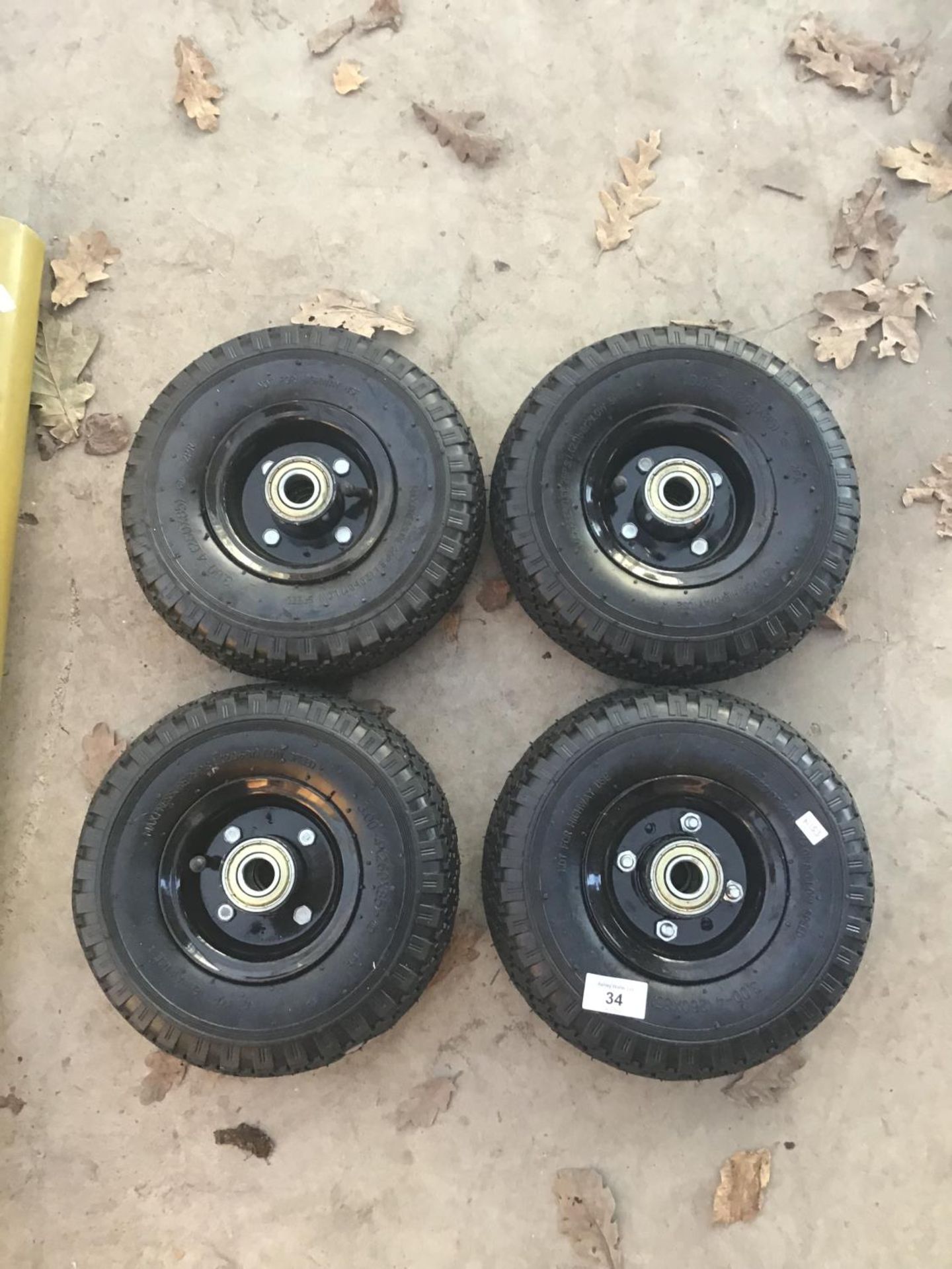 FOUR SMALL NEW WHEELS AND TYRES