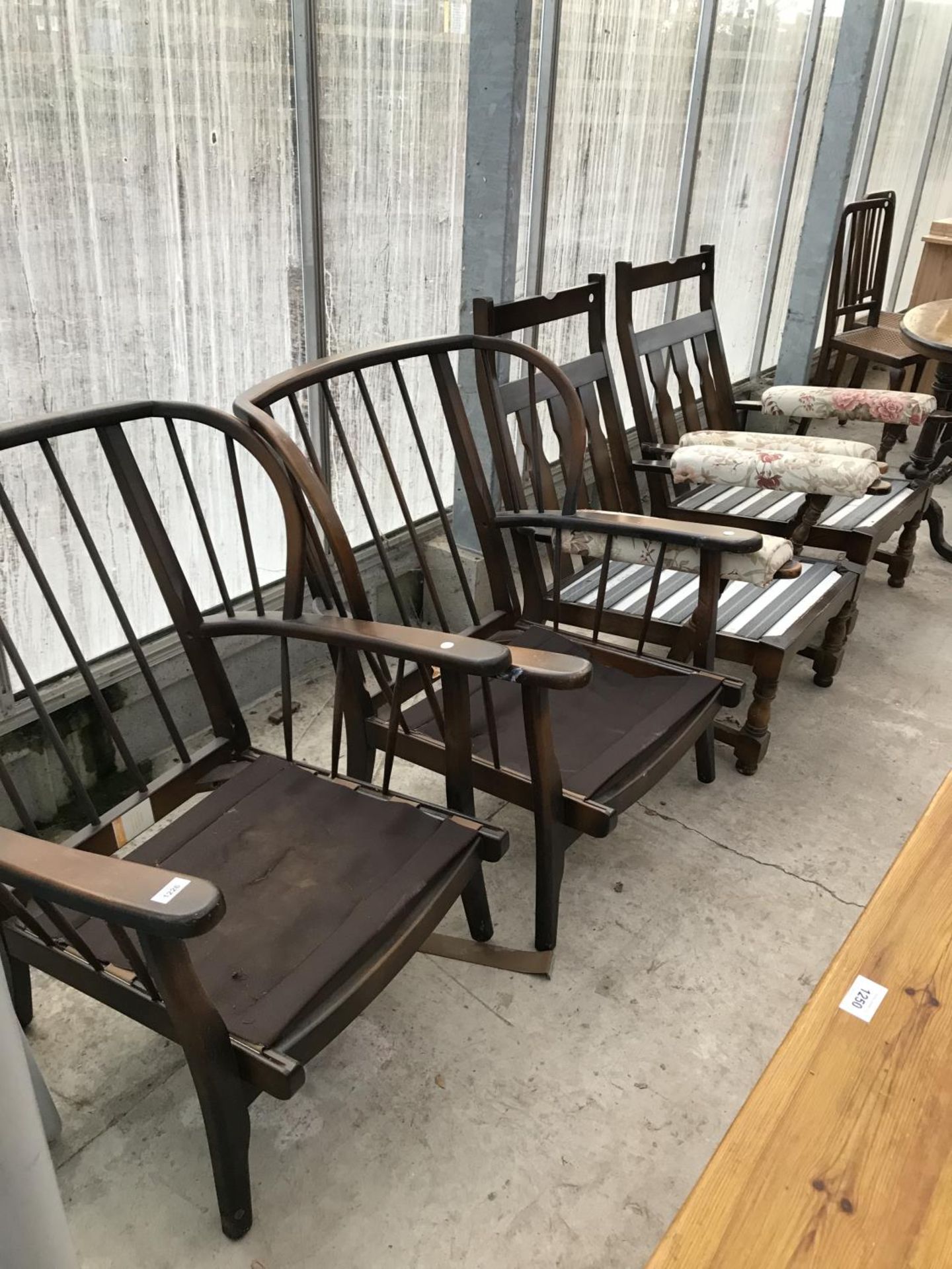 TWO ERCOL STYLE ELM ARMCHAIRS AND TWO FURTHER ELM ARMCHAIRS