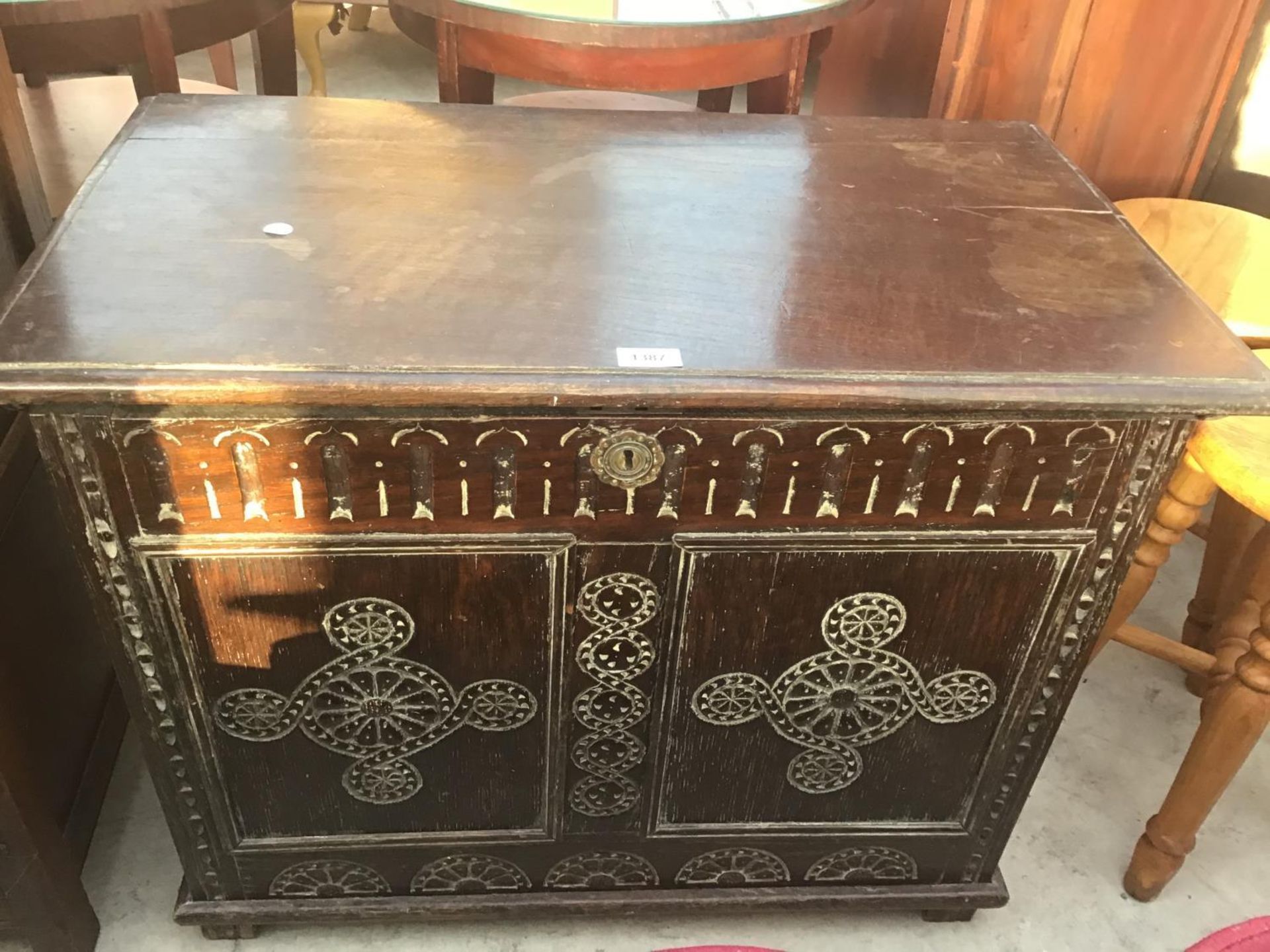 AN ORNATE CARVED OAK CHEST