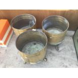 THREE LARGE BRASS PLANTERS WITH LION FACE DECORATION AND FEET