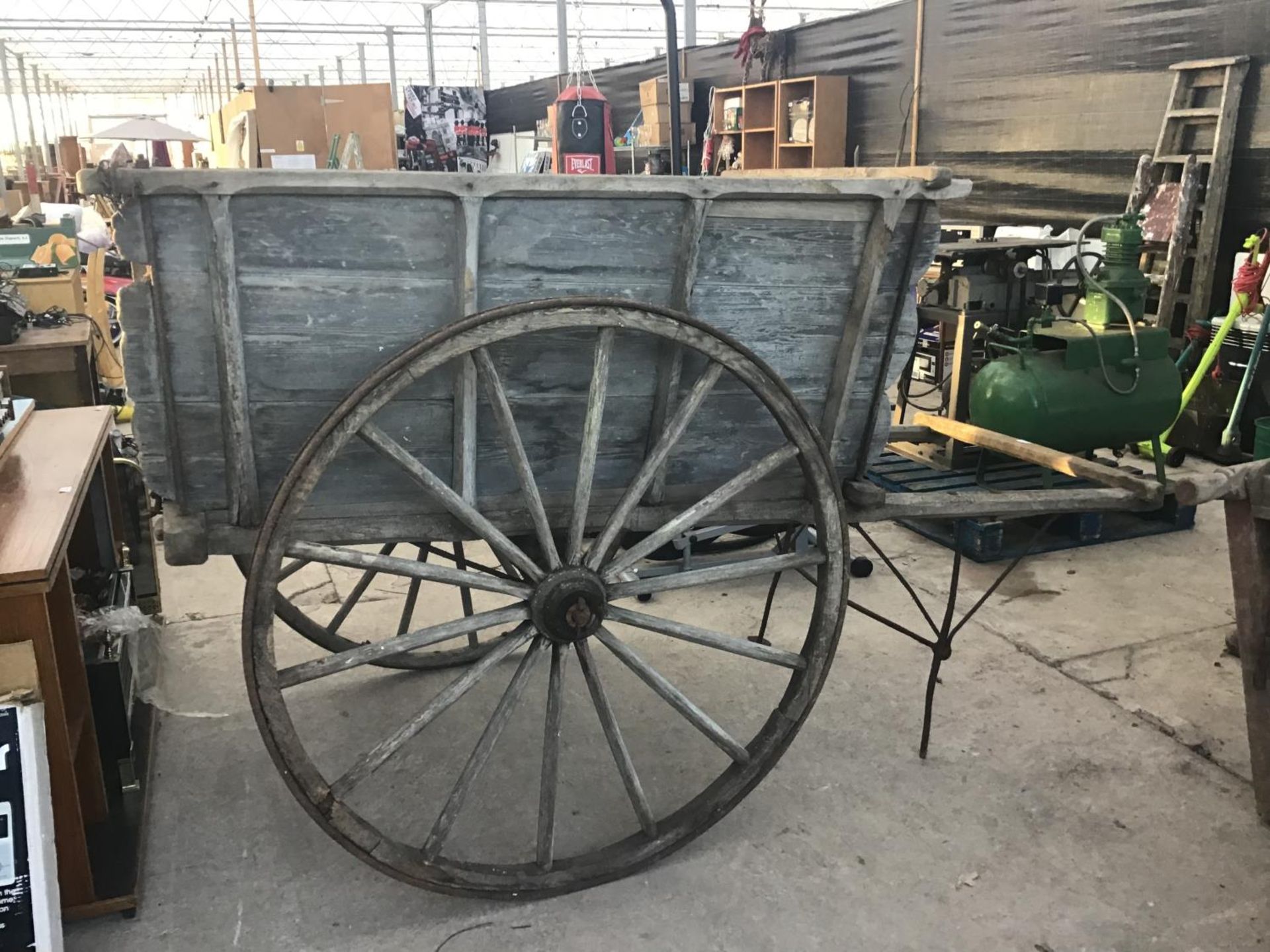 A VINTAGE WOODEN HORSE DRAWN CART WITH WOODEN METAL RIMMED WHEELS