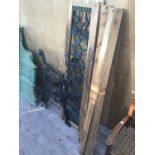 A PAIR OF CAST IRON BENCH ENDS, CAST IRON BACK PANEL AND SOME WOODEN SLATS