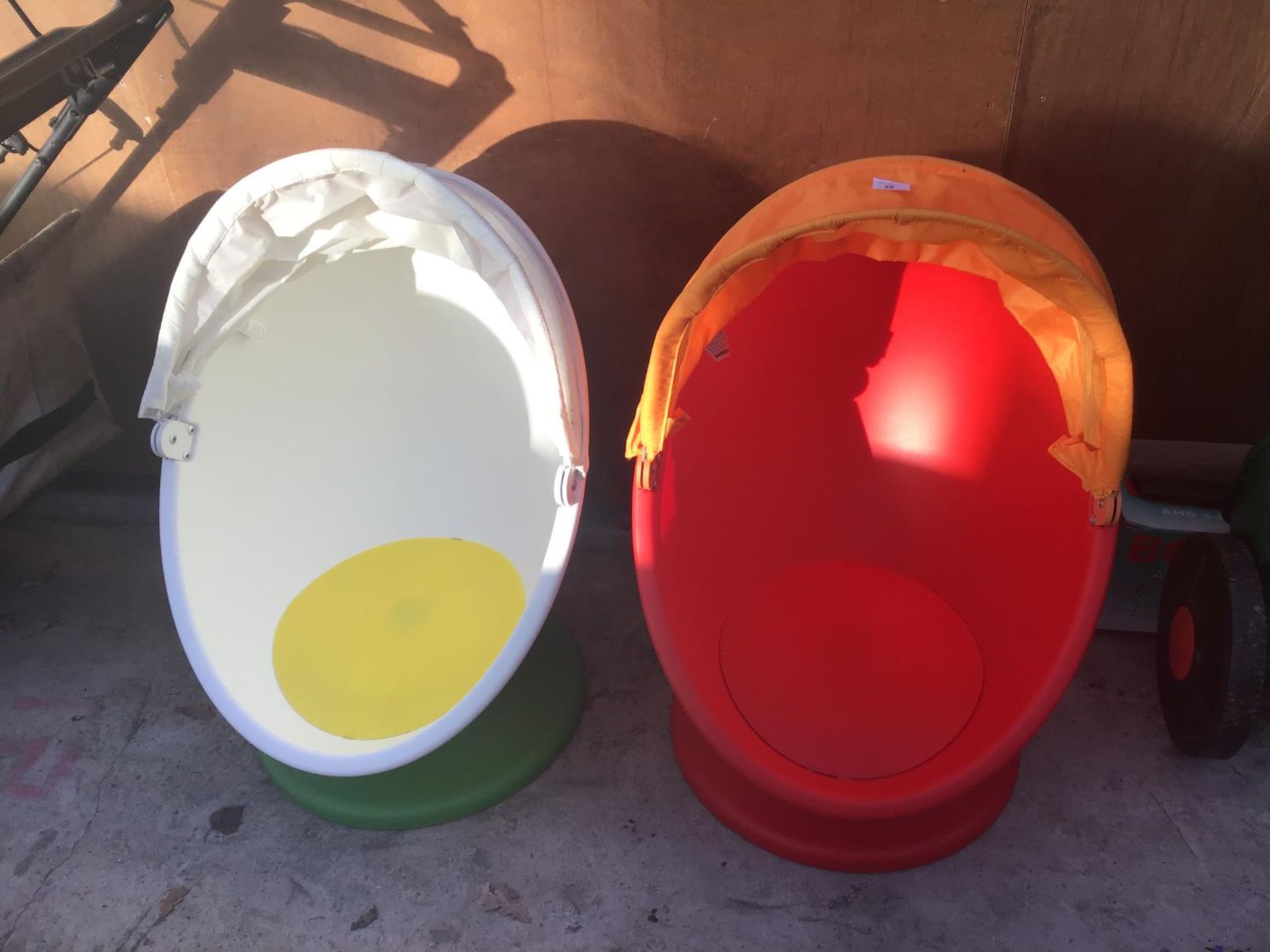 A PAIR OF CHILDREN'S EGG SHAPED CHAIRS WITH PULL OVER SHADE