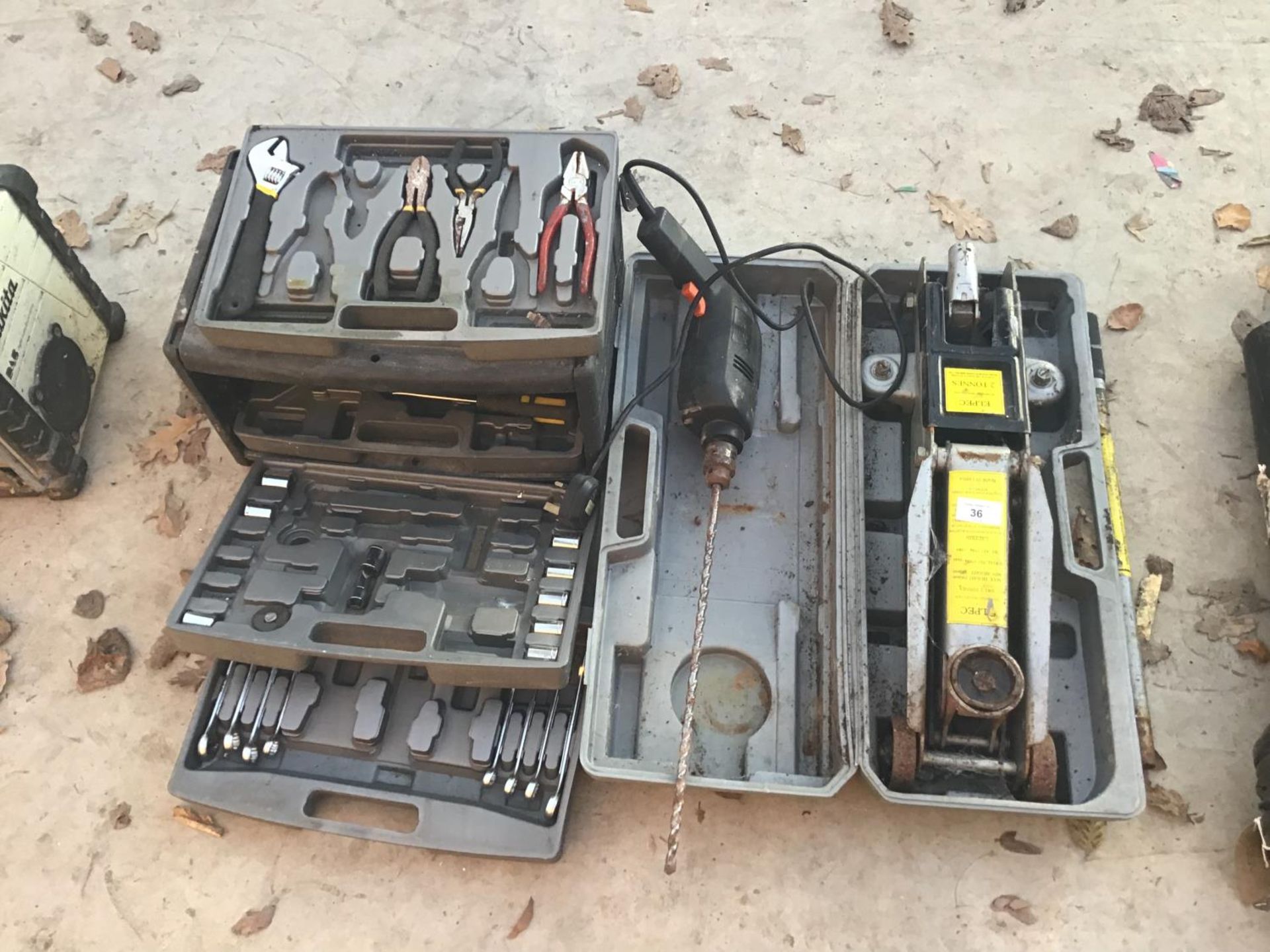 A CASED TWO TONNE JACK, DRILL, AND A TOOL BOX WITH CONTENTS TO INCLUDE SPANNERS, PLIERS, SOCKETS ETC