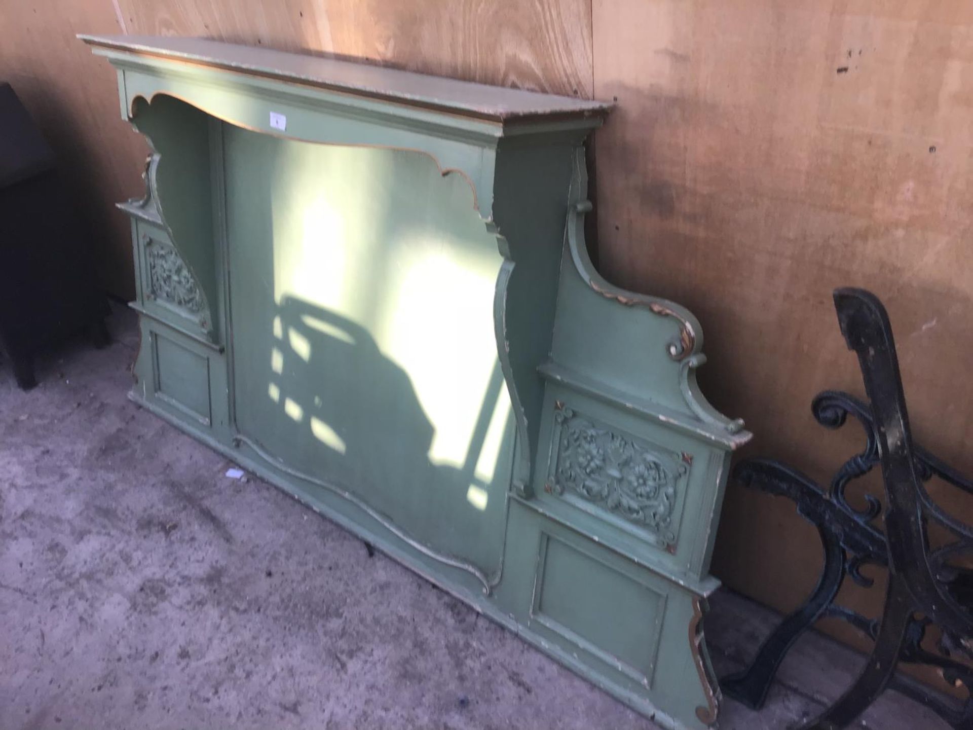 A GREEN PAINTED WOODEN ORNATE OVER MANTLE