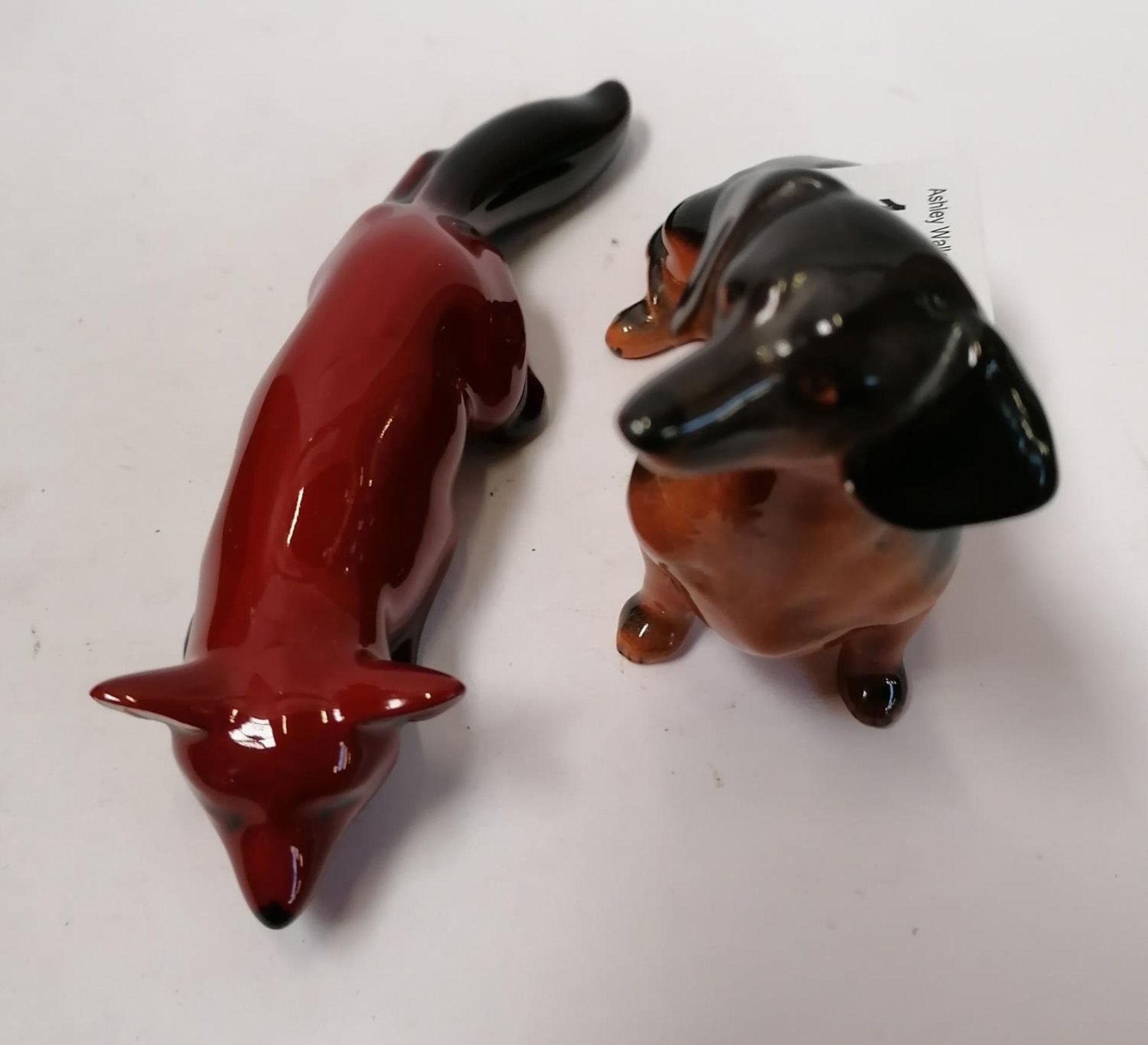 TWO CERAMIC FIGURES - BESWICK DOG AND ROYAL DOULTON FLAMBE FOX LYING DOWN