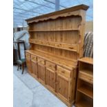A PINE DRESSER WITH FIVE LOWER DOORS AND DRAWERS AND UPPER PLATE RACK WITH SIX SMALL DRAWERS