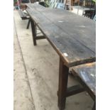A LARGE WOODEN WORK BENCH/TABLE 244CM X 88CM (CORNER MISSING)