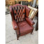 A LEATHER BUTTON AND WING BACK ARMCHAIR