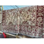 A LARGE RED PATTERNED RUG