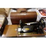 A VINTAGE CASED SINGER SEWING MACHINE