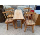 A PINE DROP LEAF DINING TABLE AND FOUR DINING CHAIRS