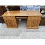 A PINE DESK WITH FOUR DOORS AND TWO DRAWERS