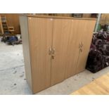 A BEECH EFFECT OFFICE CABINET WITH FOUR DOORS