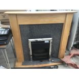 AN ELECTRIC FIRE WITH A WOOD/COMPOSITE FIREPLACE IN WORKING ORDER