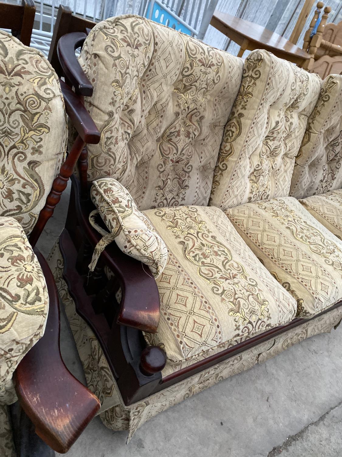 A STAINED PINE THREE SEATER SOFA AND ARMCHAIR