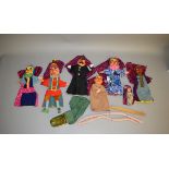 A selection of Punch and Judy glove puppets with painted heads and cloth bodies including Mr Punch,