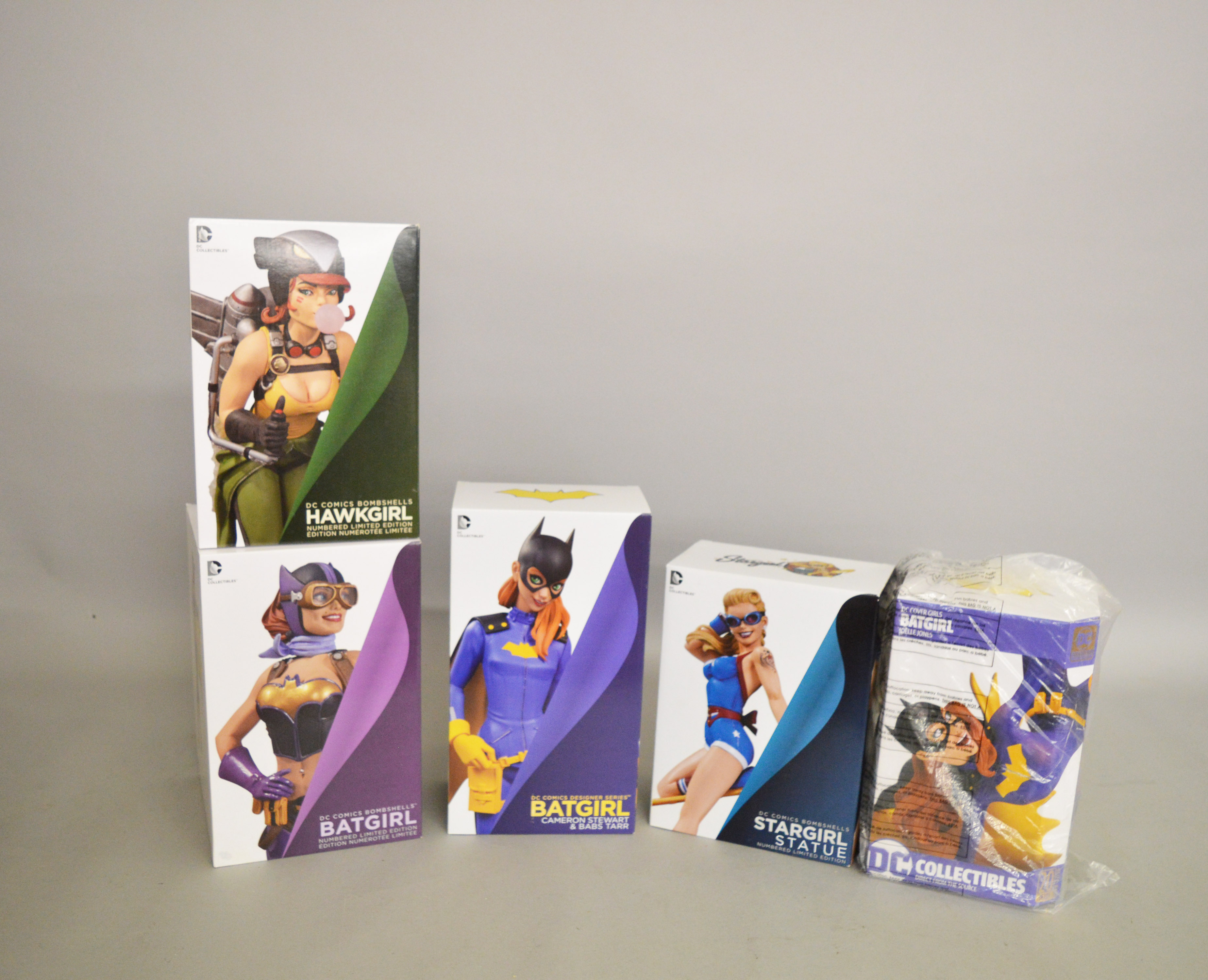 Three DC Collectibles 'Batgirl' figures together with 'Stargirl' and 'Hawkgirl' figures from their