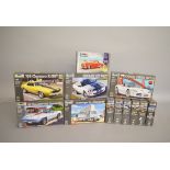 Twelve Revell plastic model kits, all 1:25 scale vehicles, including Corvette and Shelby.