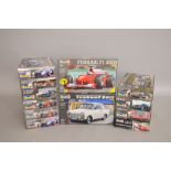 Twelve Revell plastic model kits, mainly 1:24 scale cars. Boxed, ex-shop stock.