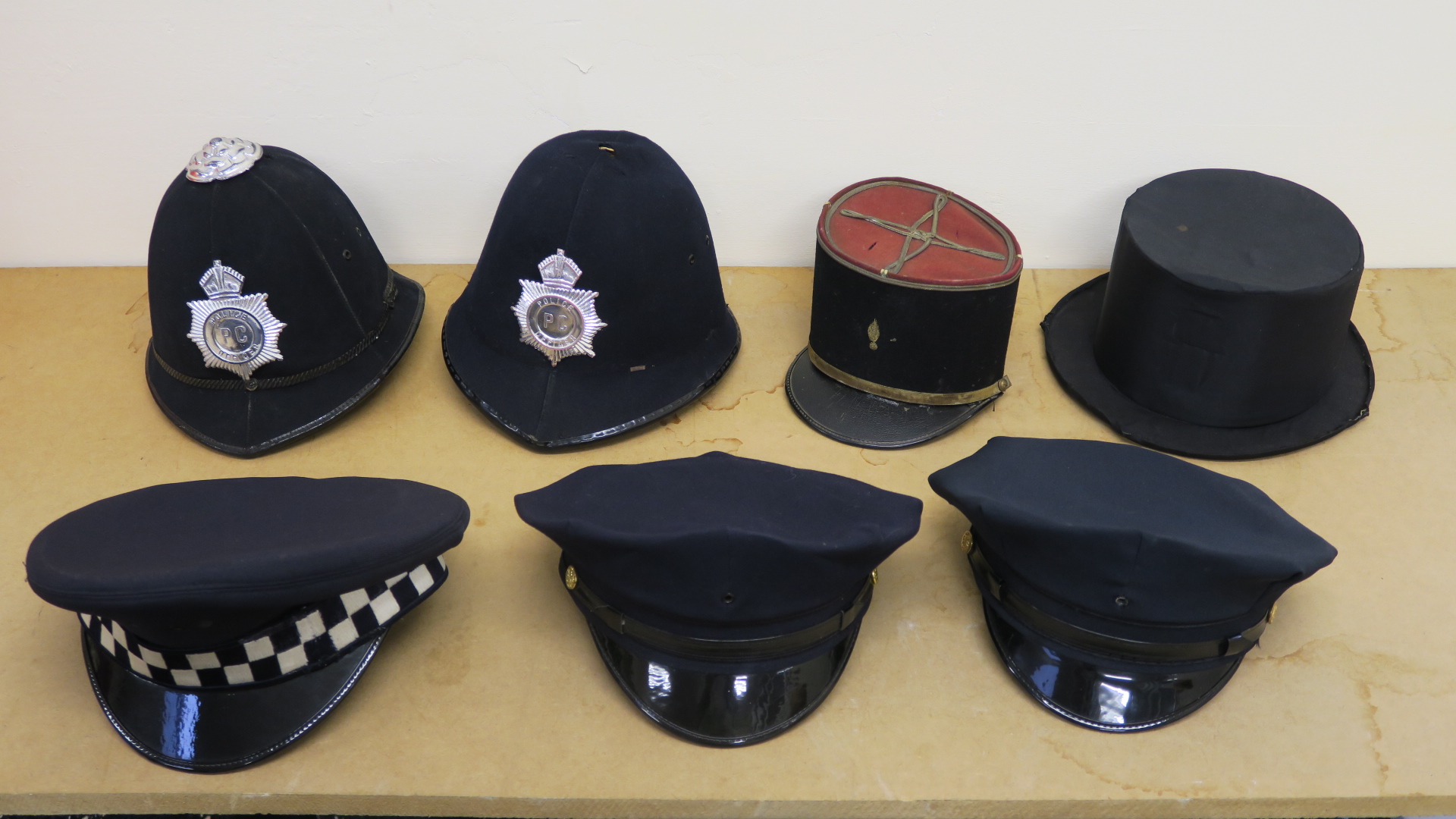Police helmets - two of American style with peak caps (size 7 3/8"),