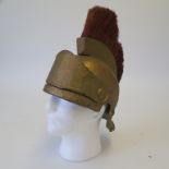 Roman army style movie prop helmet painted in gold with gold hair plume and visor,