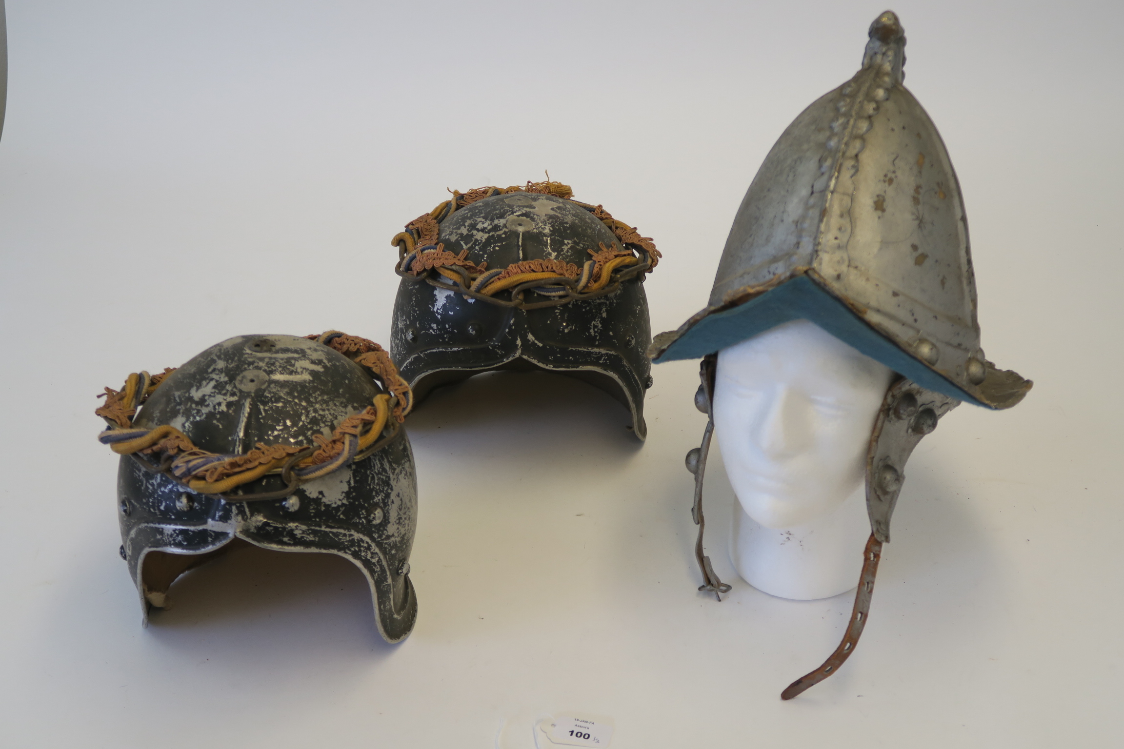 Three movie prop helmets - one Spanish Armada style with ear protector chin strap plus two metal