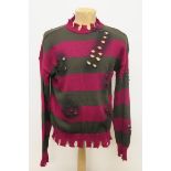 Red and green horizontal striped lacerated crew neck jumper complete with bullet holes,