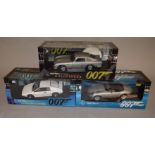 Three boxed Autoart 1:18 scale diecast model cars from their 'James Bond 007' range,