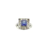 A sapphire & diamond cluster ring, the cushion cut royal blue sapphire weighs approx 3.