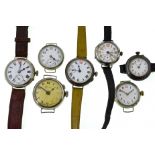 Seven early 20th century mechanical nickel watches, four with uncracked white enamel dials,