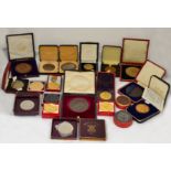 A boxed quantity of 20th century commemorative medallions, most in contemporary boxes,