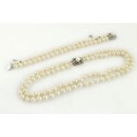 A two row cultured pearl necklet, clasp stamped sterling,