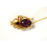 A vintage spider shaped brooch with amethyst-coloured glass stones for the body and head.