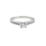 A platinum H/M diamond ring approx 0.75cts, the central set round brilliant cut diamond approx 0.