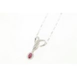 A ruby & diamond pendant H/M 14ct, suspended by a 9ct H/M chain,