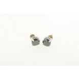 A pair of black diamond stud earrings with screw back fittings, set in white metal tested 18ct gold,