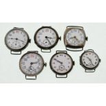 Six early 20th century silver watch heads, the whit enamel dials in overall good condition,