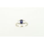 A sapphire & diamond cluster three stone ring H/M 18ct, the central set sapphire approx 0.