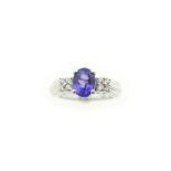 A tanzanite & diamond ring, the central oval tanzanite weighs approx 2.