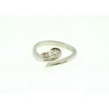 An 18ct H/M two stone Diamond twist set ring, approx total weight 0.