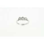 An 18ct H/M three stone diamond ring, the three round brilliant cut diamonds total approx 0.
